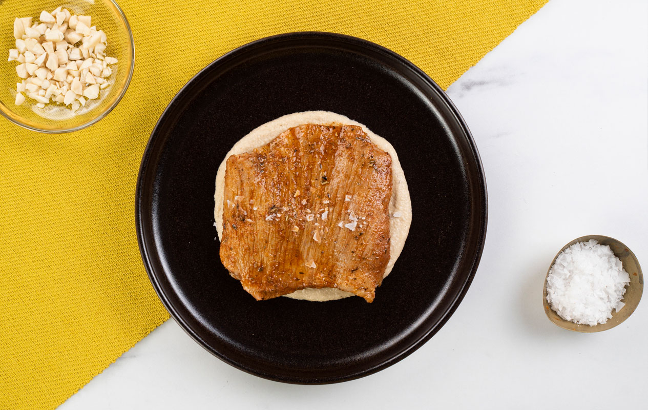 Secreto marinado con salsa de almendras